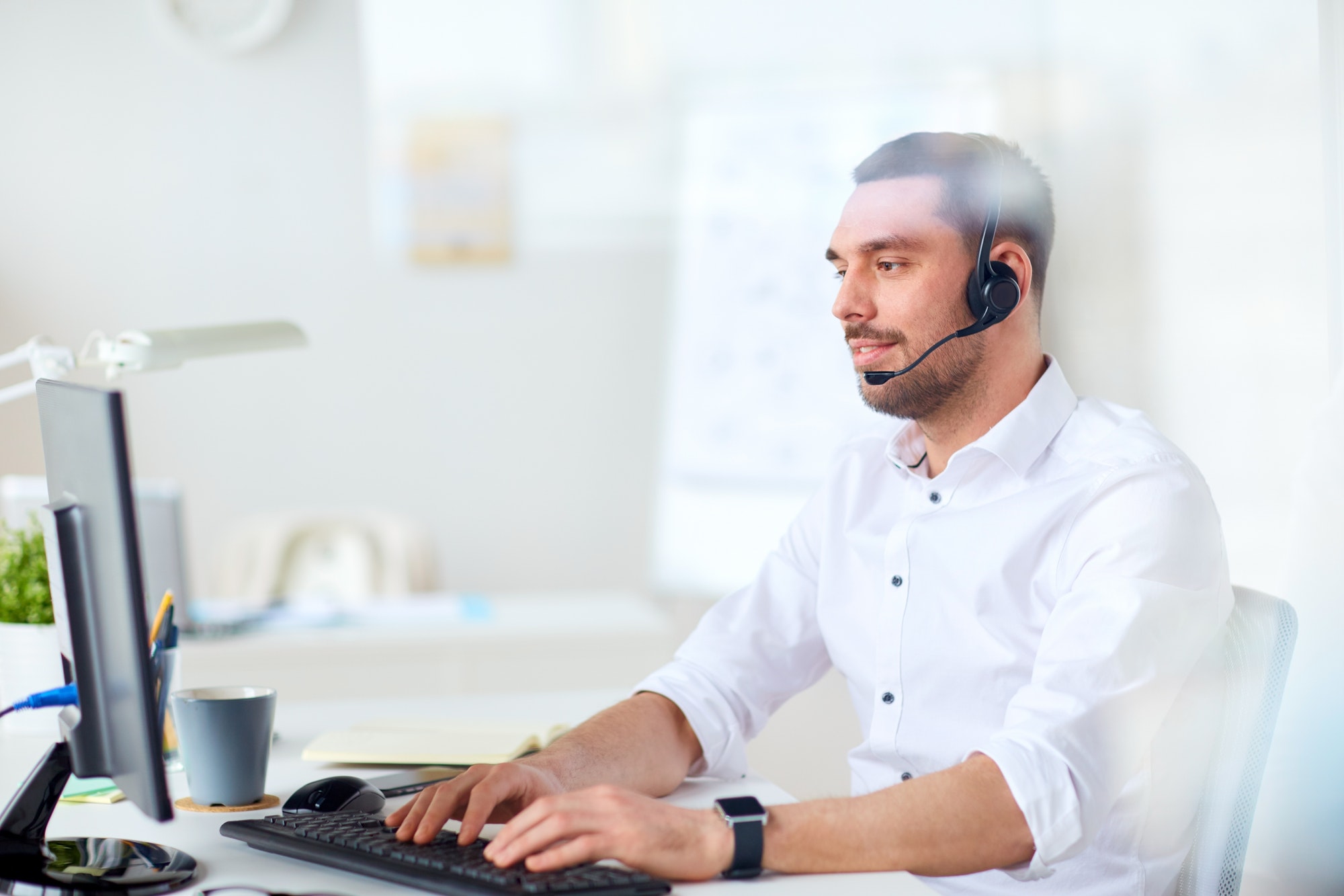 businessman with headset and computer at office